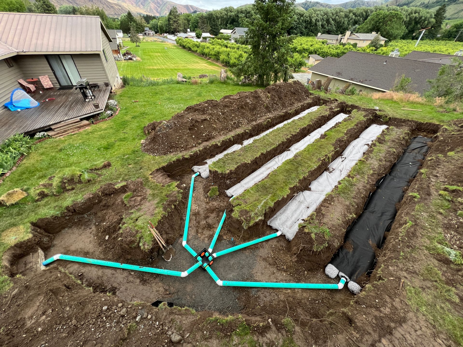 An aerial view of a drainage system being installed in a yard.