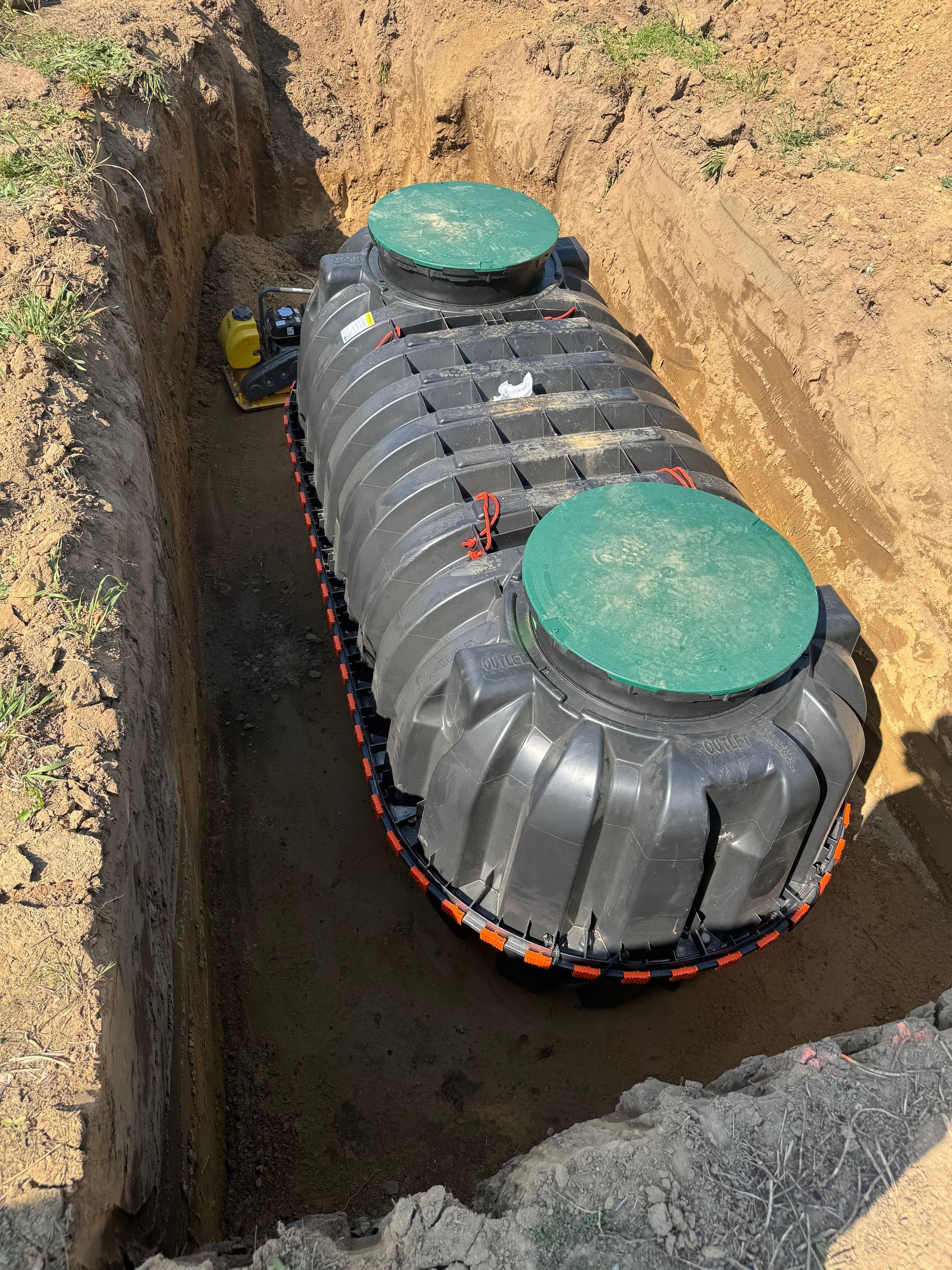 A septic tank is sitting in a hole in the ground.