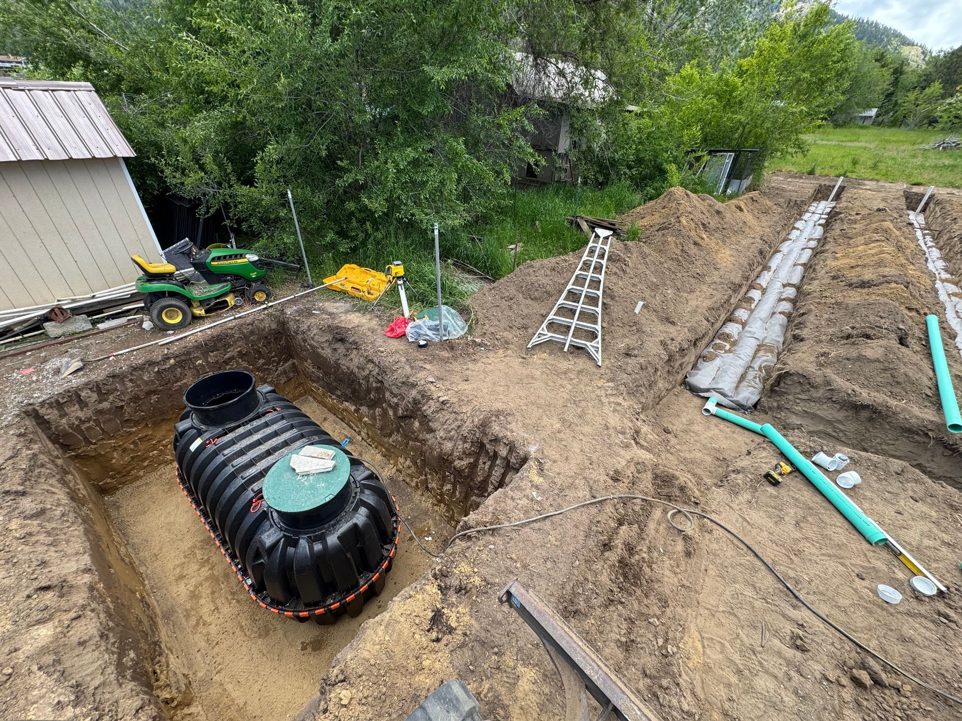 A septic tank is being installed in a hole in the ground.