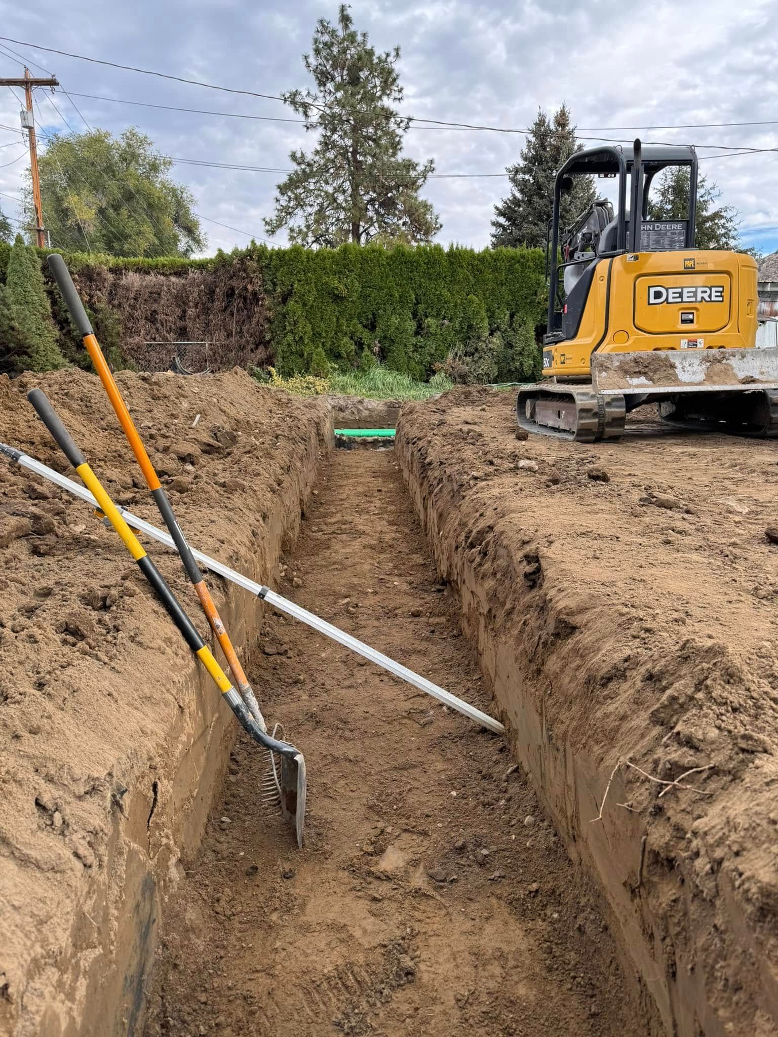 A bulldozer is digging a trench in the dirt.